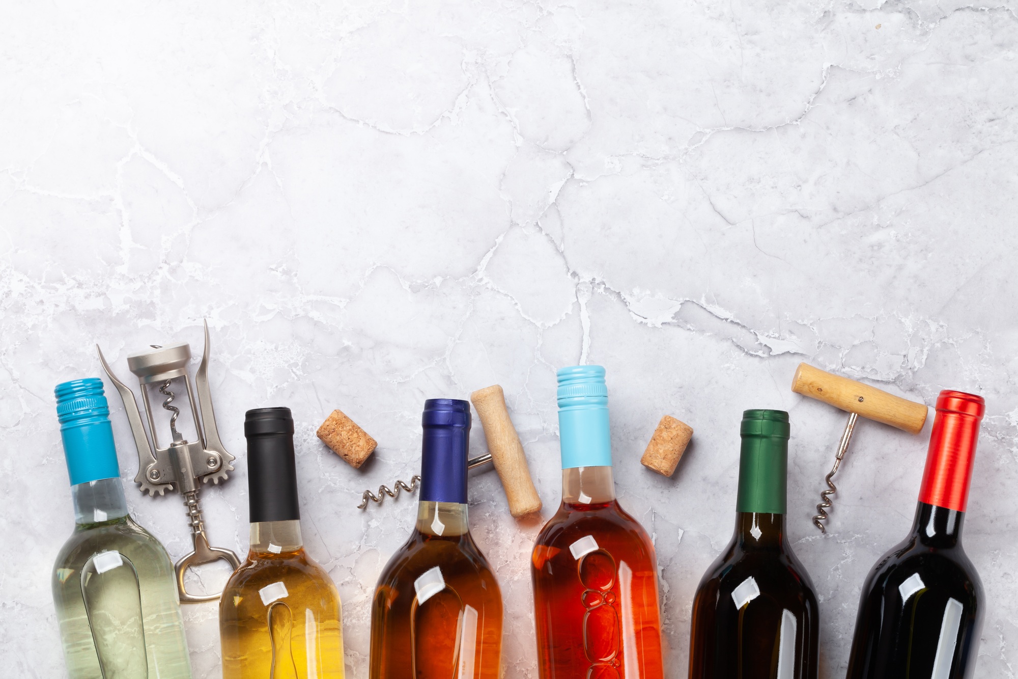 Various wine bottles and corkscrews